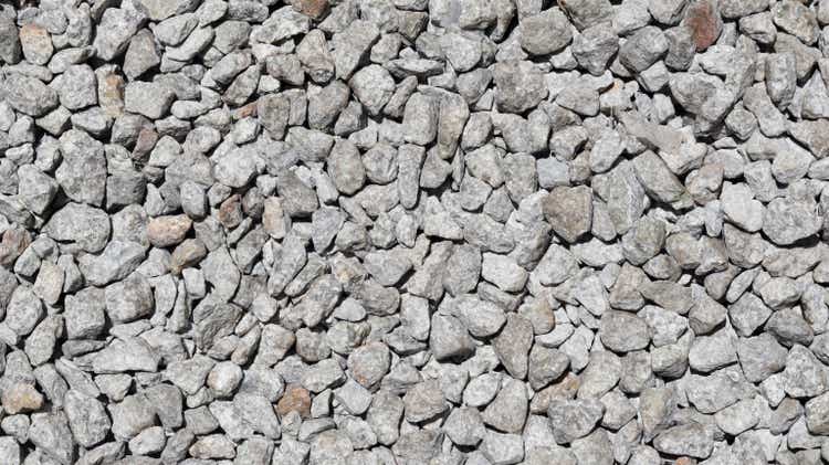 Crushed stone aggregate texture background and backdrop material design.