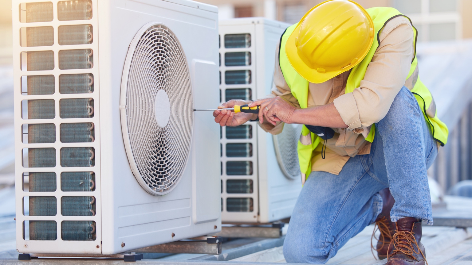 Professional HVAC technician installing air conditioning unit