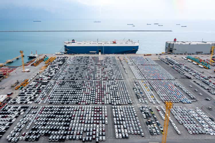 Large RoRo (Roll-on Roll-off) into Commercial dock loading new car product order for sale for export international on the sea, business service transportation concept, photograph Drone