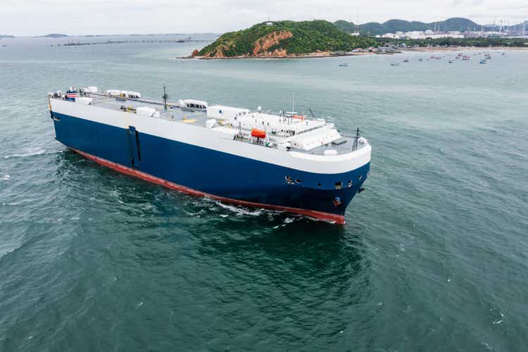 Roll-on Roll-of ship loading new cars line up . Automotive container carriers floating in sea, business services import export international by Roll-on Roll-of ship large in the Ocean freight,