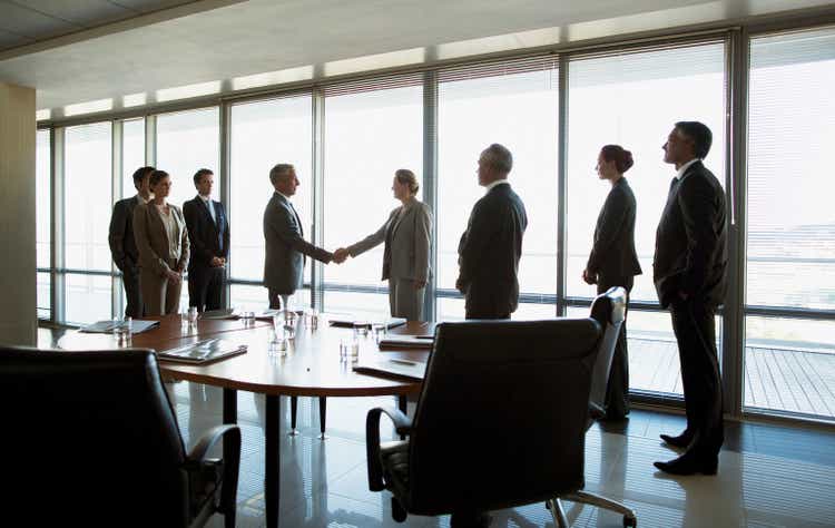 Business people shaking hands in a conference room