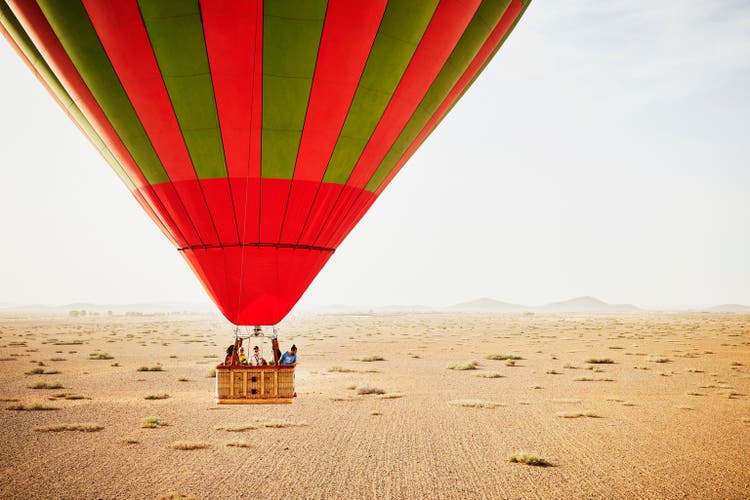 Wide shot of family and friends on early morning hot air balloon ride