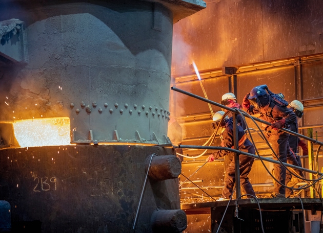Safety manager checking molten steel pour into mould