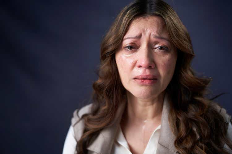 Portrait of anxious crying mature woman