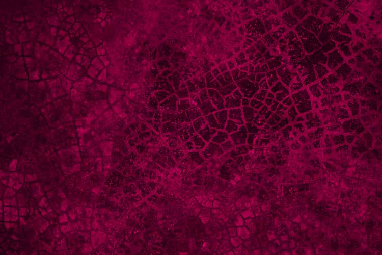 Black red abstract grunge texture background. Toned cracked concrete wall. Viva magenta. Color 2023.