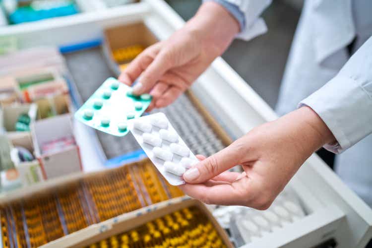 Female pharmacist carries medications
