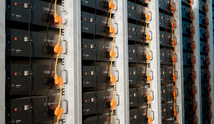 Image of a battery energy storage system consisting of several lithium battery modules placed side by side. This system is used to store renewable energy and then use it when needed. 3d rendering.