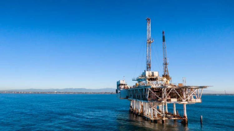 Close Off-Shore Oil and Gas Drilling Rig with Cargo Ships in Distance at Dusk Near Long Beach/Los Angeles, California at Dusk on a Clear Morning