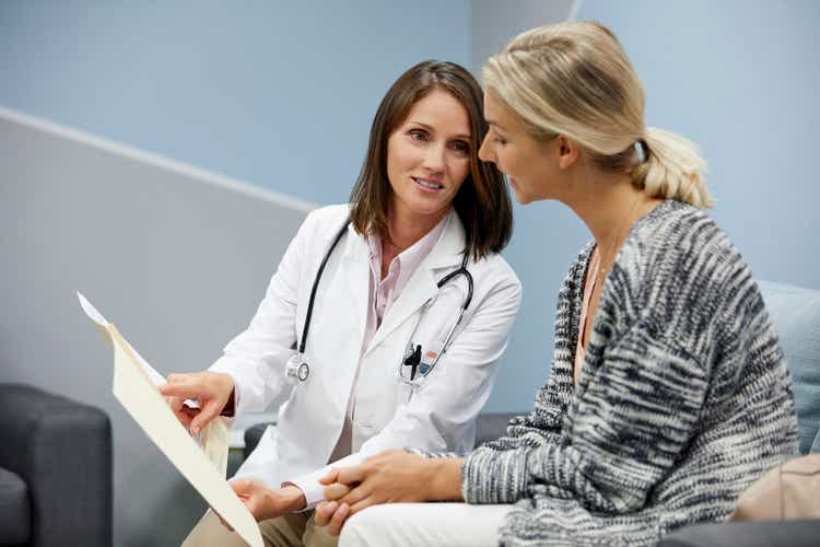 Female doctor showing medical report to patient