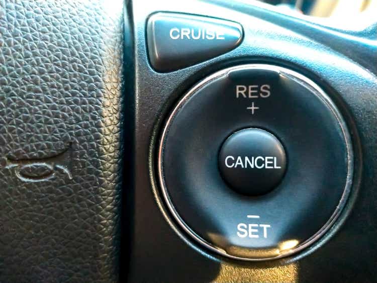 Cruise control button in conventional modern car. Car instrument panel, interior dashboard control.