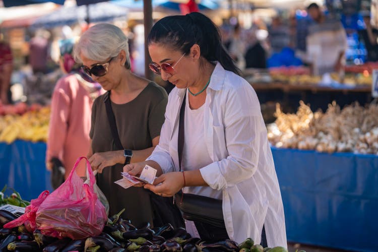 Photo of senior woman and adult friend shopping in farmer