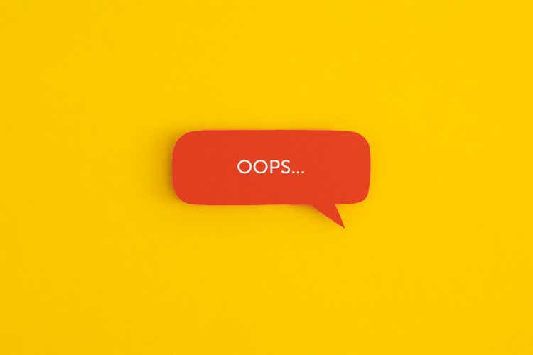 Paper speech bubble with the word "OOPS" on a yellow background. Top view with copy space. Flat lay.