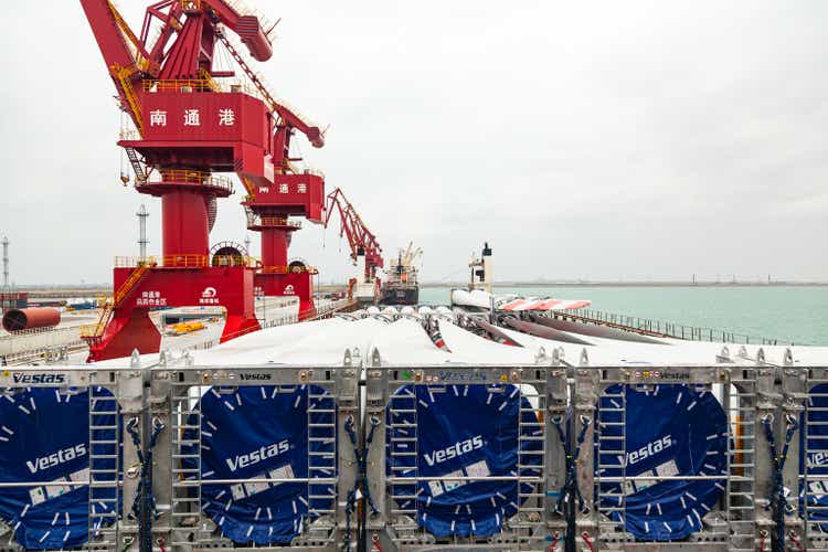 Loading the blades of Vestas wind turbines in the seaport of Natong, China by port cranes onto a cargo ship.
