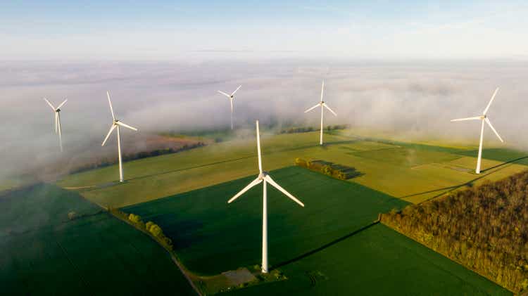 Aerial view of wind turbines on a misty morning