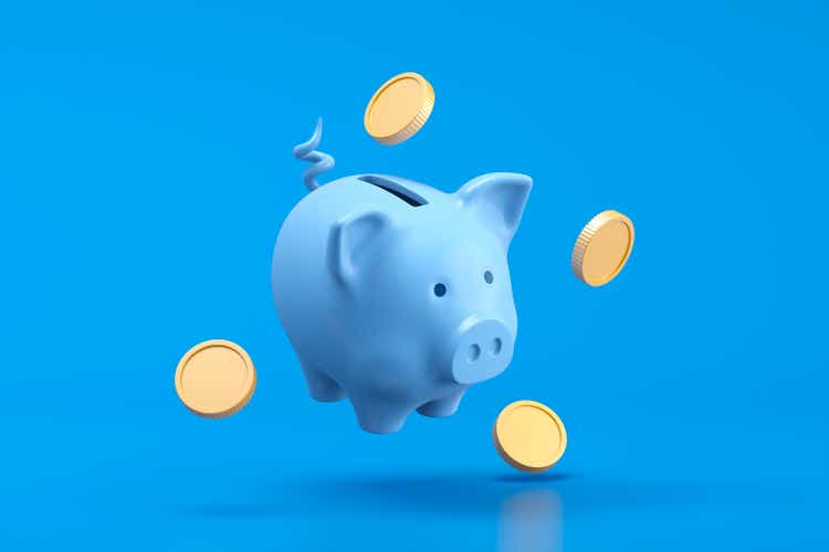 Piggy bank and money coin savings concept on blue background