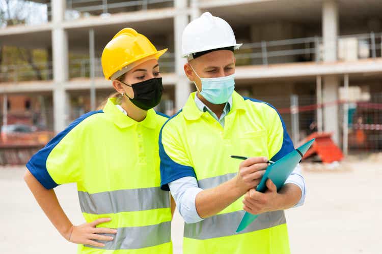 Civil engineers in masks checking work process