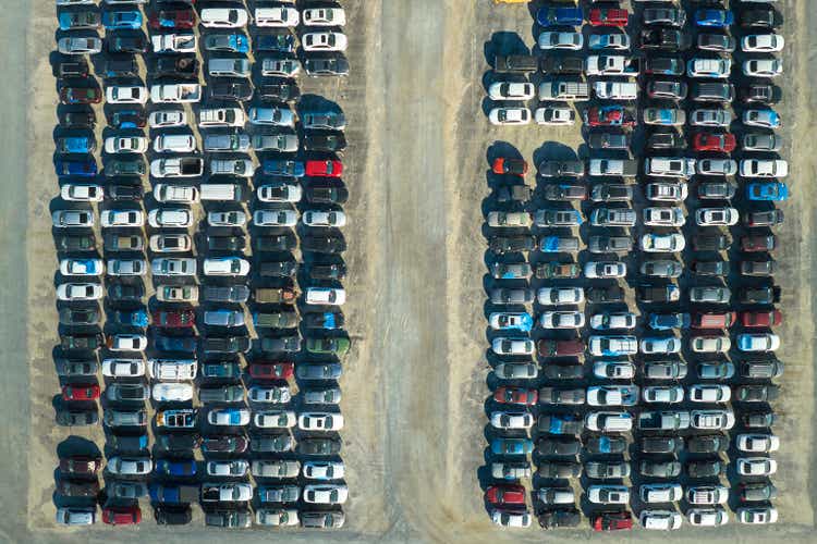 Aerial view of auction reseller company big parking lot with parked cars ready for remarketing services. Sales of secondhand vehicles