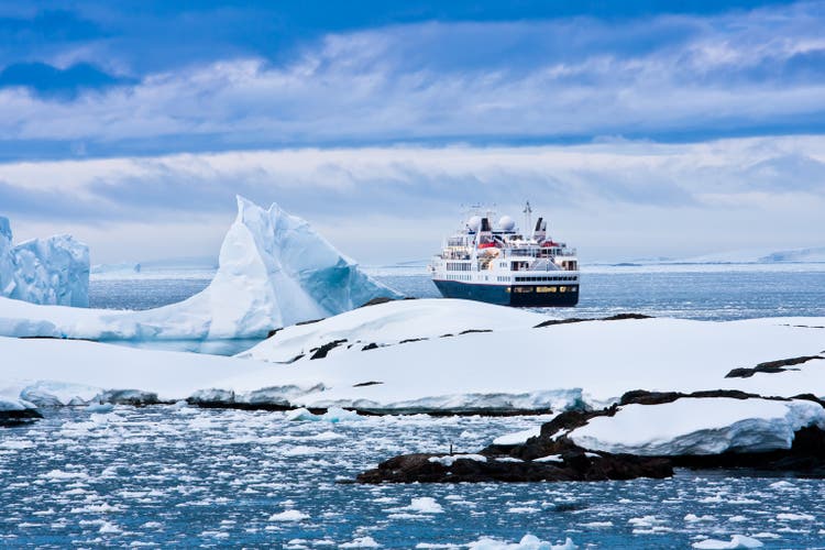 Overview of large cruise ship sailing through icy waters