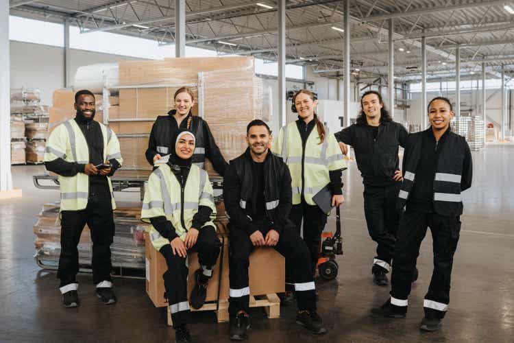 Portrait of smiling multiracial warehouse workers at distribution warehouse