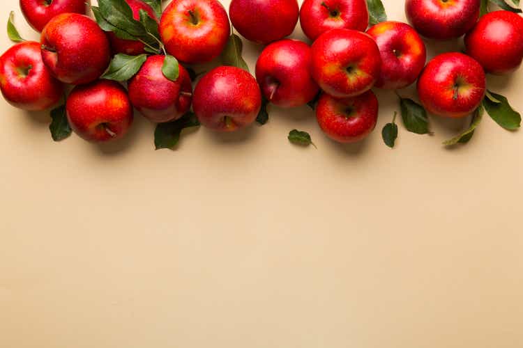 Many red apples on colored background, top view. Autumn pattern with fresh apple above view with copy space for design or text