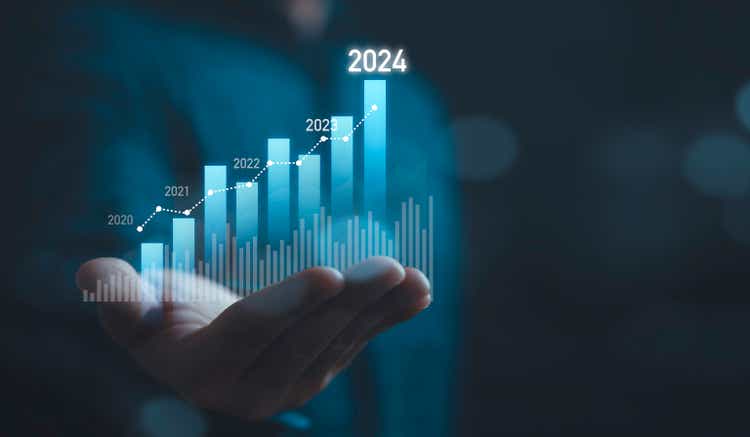 Businessman holding glowing virtual technical graph and chart for analysis stock market in 2024, technology investment and value investment concept.
