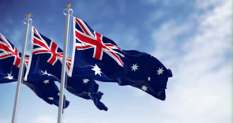 Three Australia national flags waving in the wind on a clear day