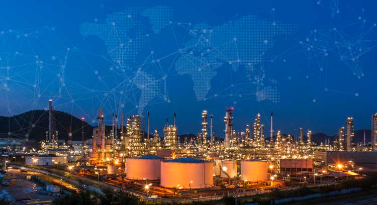 Oil refinery at twilight and night with industrial physical system icon diagram Supports the concept of Industry 4.0 technology.