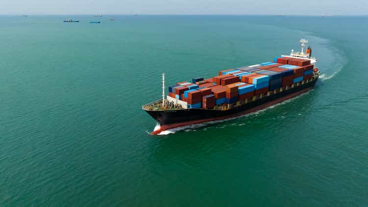 Container ship carrying container import and export of international business cargo logistic transportation by container ship in sea, photography aerial view from drone,