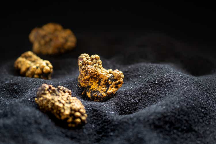 Pure gold from the mine that was unearthed was placed on the black sand.