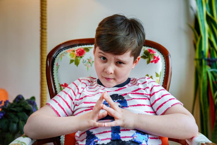 Little boy looking at the camera with a silly face