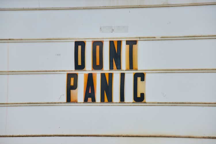 Detail of road sign all white with black capital letters DONT PANIC from Hitchhikers Guide to the Galaxy.jpg