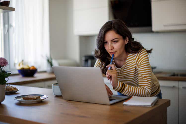 Young woman using a laptop while working from home