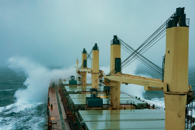 Giant cargo ship colliding with waves