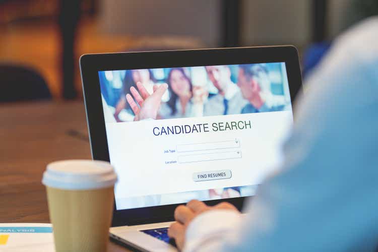 Businessman looking at recruitment website on a laptop computer