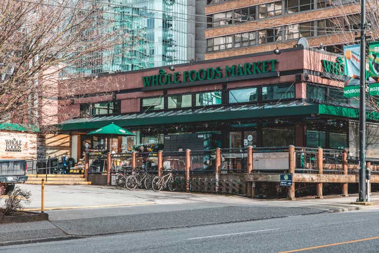 The photograph showcases the prominent Whole Foods Store located on Robson Street in Vancouver.