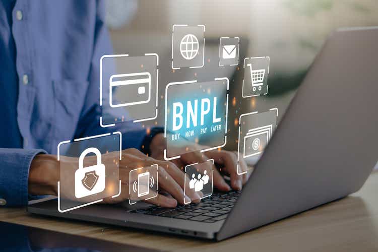 BNPL Buy now pay later online shopping concept. Businessmen using laptop with icons of BNPL.e-commerce.