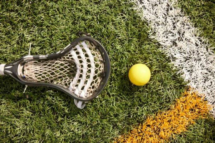 Close-Up of Lacrosse Scoop and Ball on the Field.