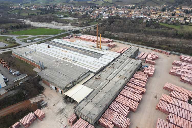 aerial view of brick and construction elements factory building in small town