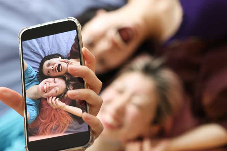 Female Friends Enjoying Selfie Together At Home