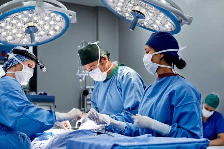Women's surgeon operating patient in an emergency room