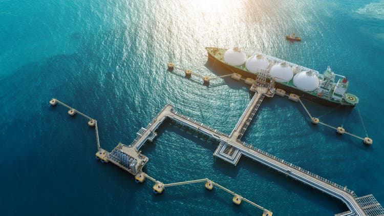 LNG (Liquified Natural Gas) tanker anchored in Gas terminal gas tanks for storage. Oil Crude Gas Tanker Ship. LPG at Tanker Bay Petroleum Chemical or Methane freighter export import transportation and logistics