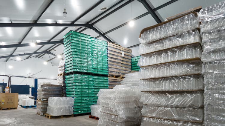 Empty plastic bottles stacked inside a Water Bottling Plant Warehouse