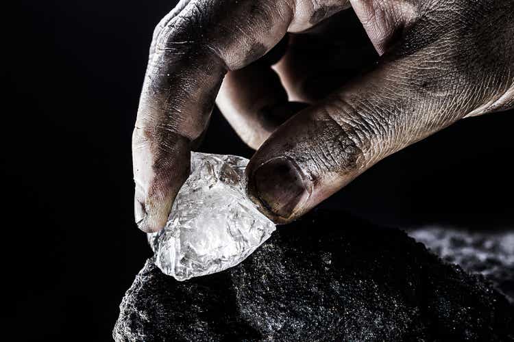 hand removing rare stone from a mine, chinese diamond digging
