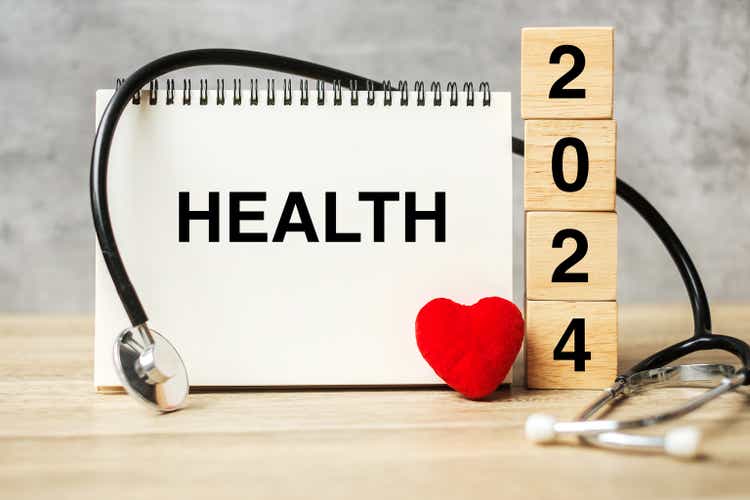 2024 Happy New Year for healthcare, Insurance, Wellness and medical concept. Stethoscope of doctor on table