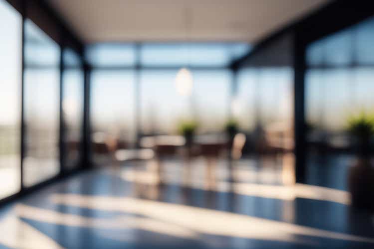 Defocused background image of spacious corridor in modern office.