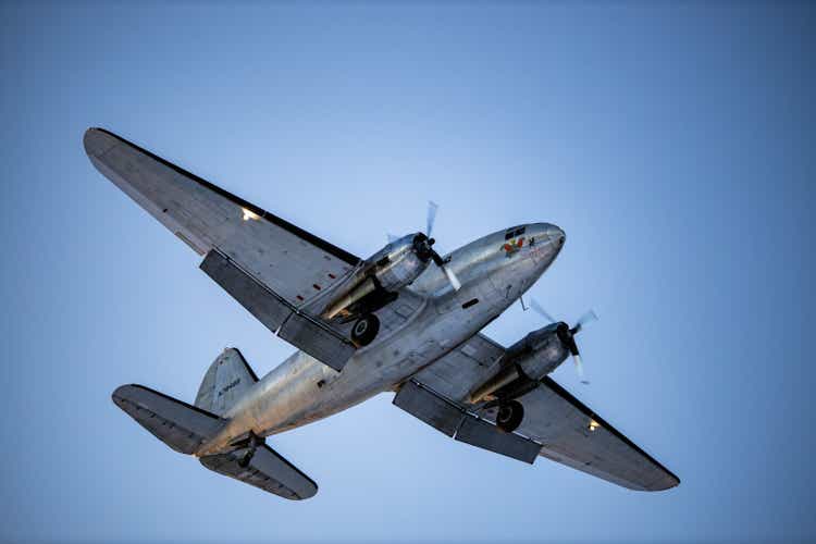 Curtiss Wright C-46R on approach for landing over Old Town Kenai, Alaska