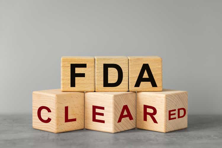 FDA approved, words on wooden blocks. Beautiful gray background, business concept, confirmation of inspection and registration of drugs and medical devices used in medicine