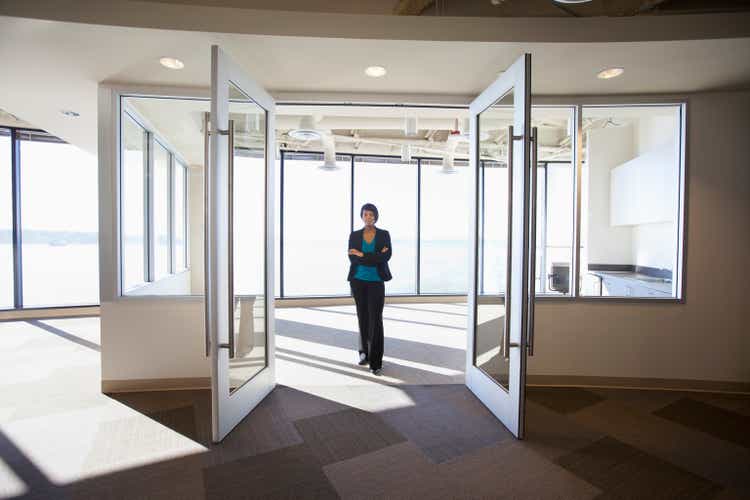 African American businesswoman standing in empty office