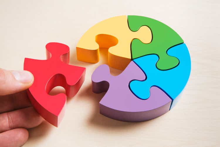 Pie shaped puzzle, hand positioning last piece