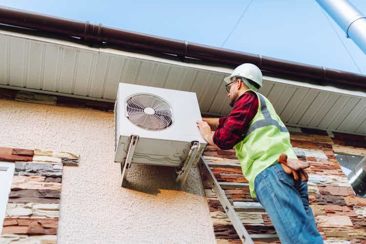 Unified technicians repairing heat pumps